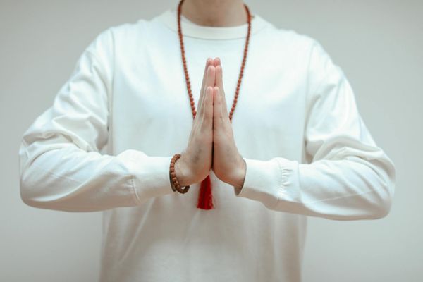 Close up of hands in prayer position during yoga.