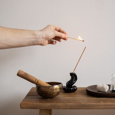 Meditation bowl and incense for relaxing atmosphere.