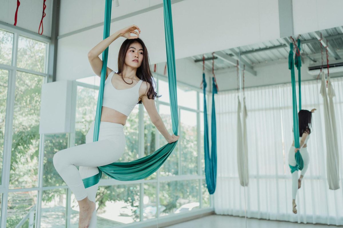 Woman practicing peaceful yoga flow in a bright studio.