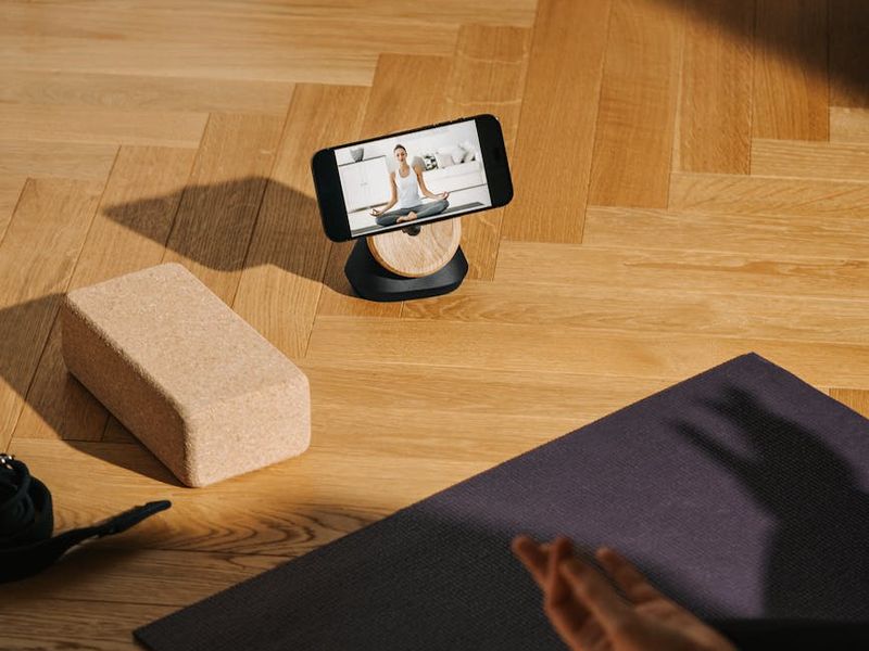 Yoga blocks and mat on a wooden floor.